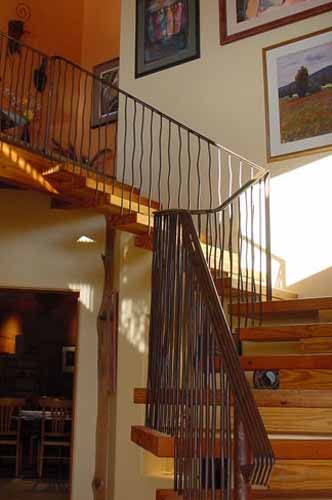 Interior wooden staircase that is an architectural feature of a Poured Earth home in Prescott, AZ.